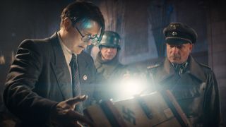 Still from the movie Indiana Jones and the Dial of Destiny. Here we see w Nazi soldiers and a Nazi scientist opening a wooden crate that has a swastika printed on it.