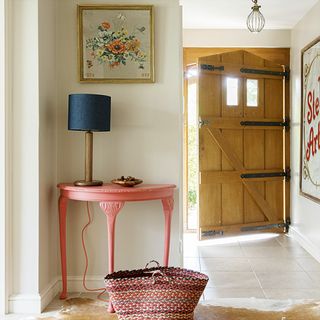 white hallway with pink table and lamp