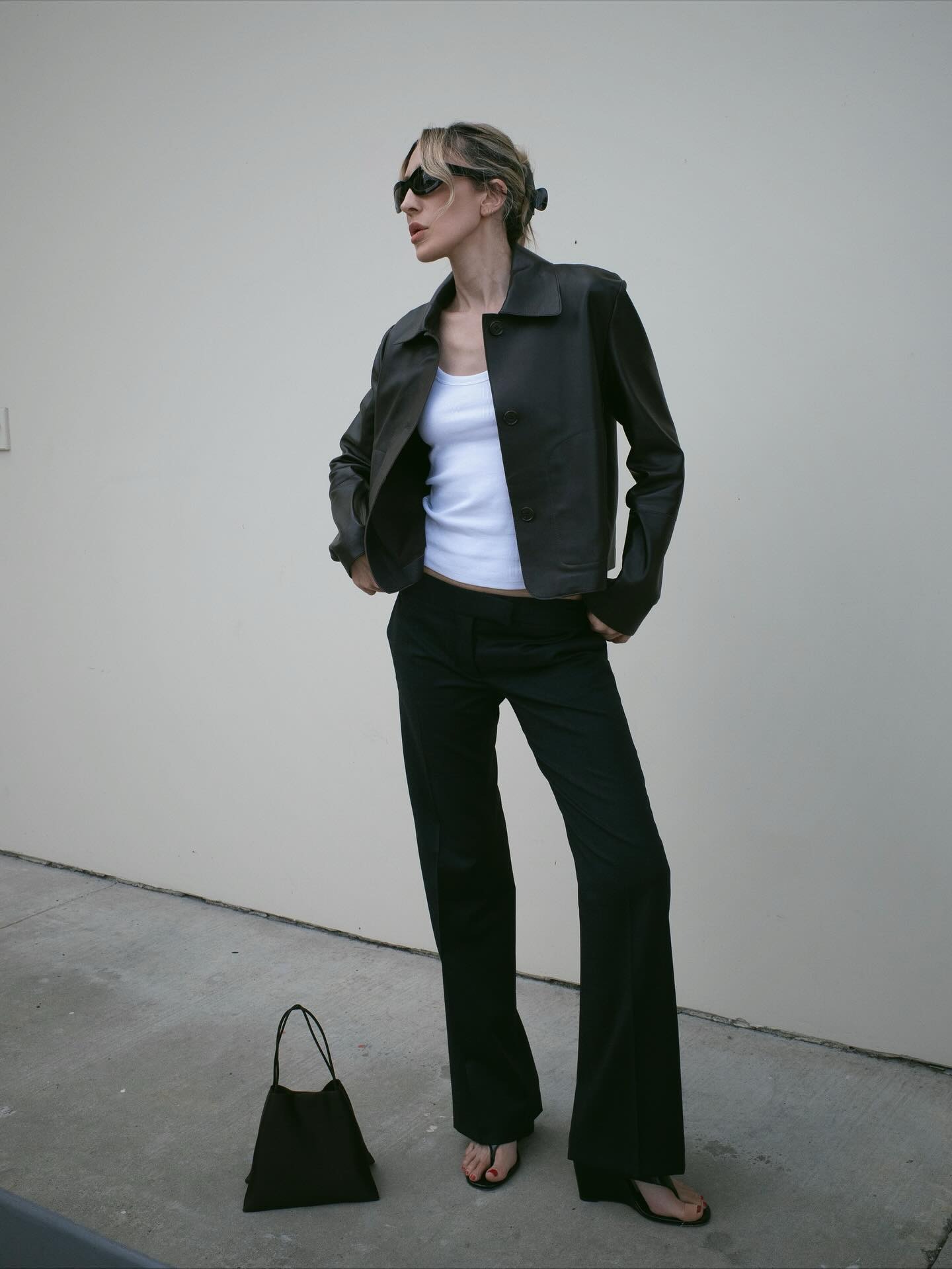 Influencer wearing black flare trousers and wedge thong sandals