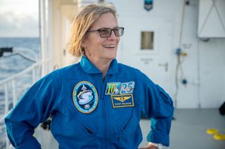 Kathy Sullivan, on the DSSV Pressure Drop, wearing the mission patch for her dive ("The Most Vertical Girl in the World") and both her NASA-issued Mach 25 badge (at right) and her new "10+ KM" emblem.