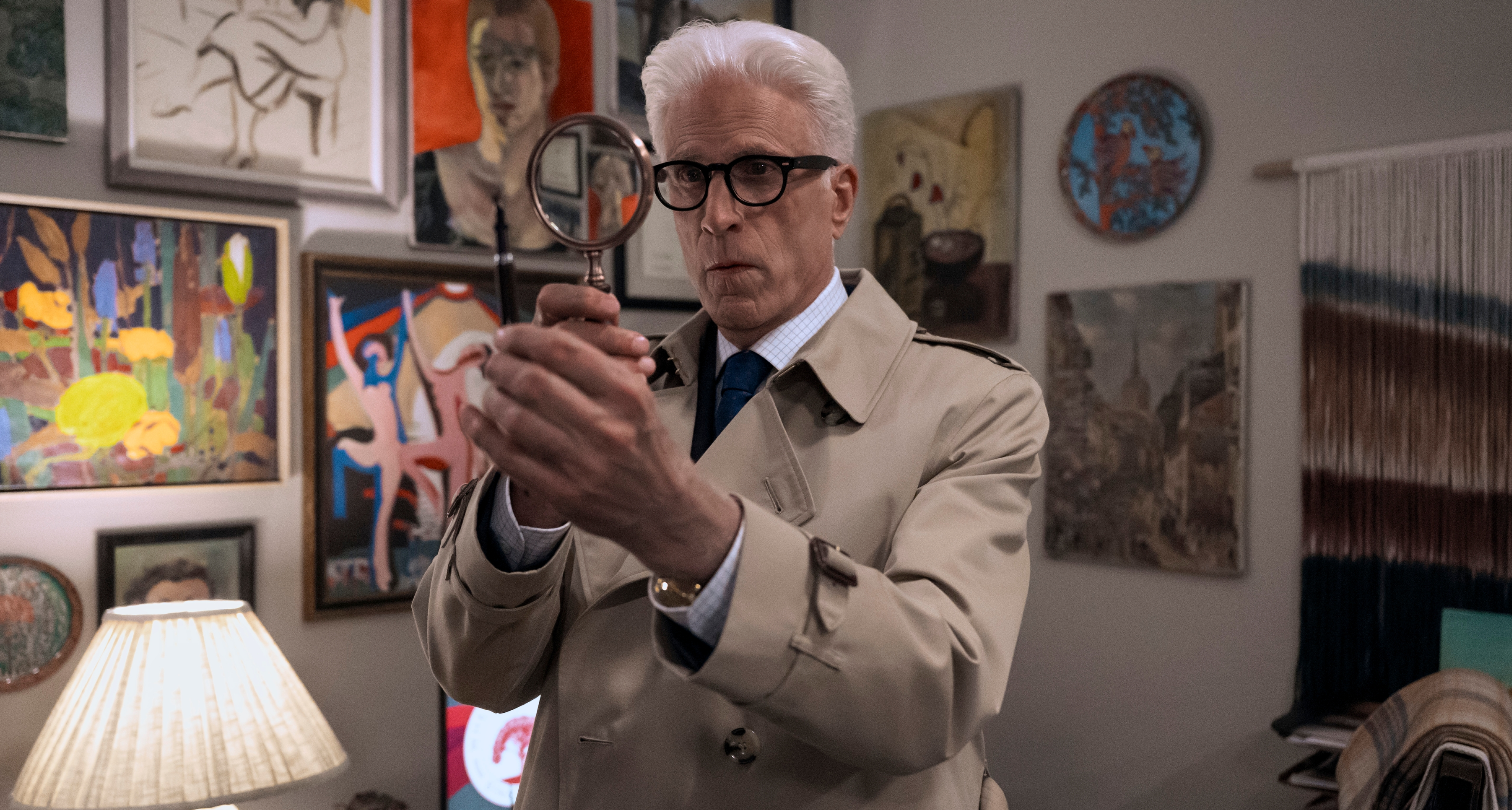 ted danson as charles wearing a trench coat and holding a magnifying glass investigating in a man on the inside season 2