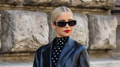 mac ruby woo lipstick - Caro Daur wearing a black leather blazer, black sunglasses and red lipstick - gettyimages1710371193