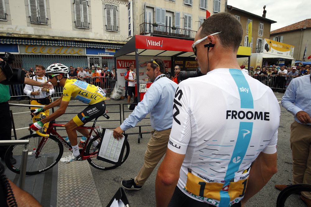 Chris Froome watches Fabio Aru ride by in yellow before the start of stage 13 at the Tour de France