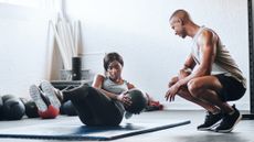 Woman trying cross training with medicine balls for the first time