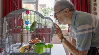 Man talking to pet birds