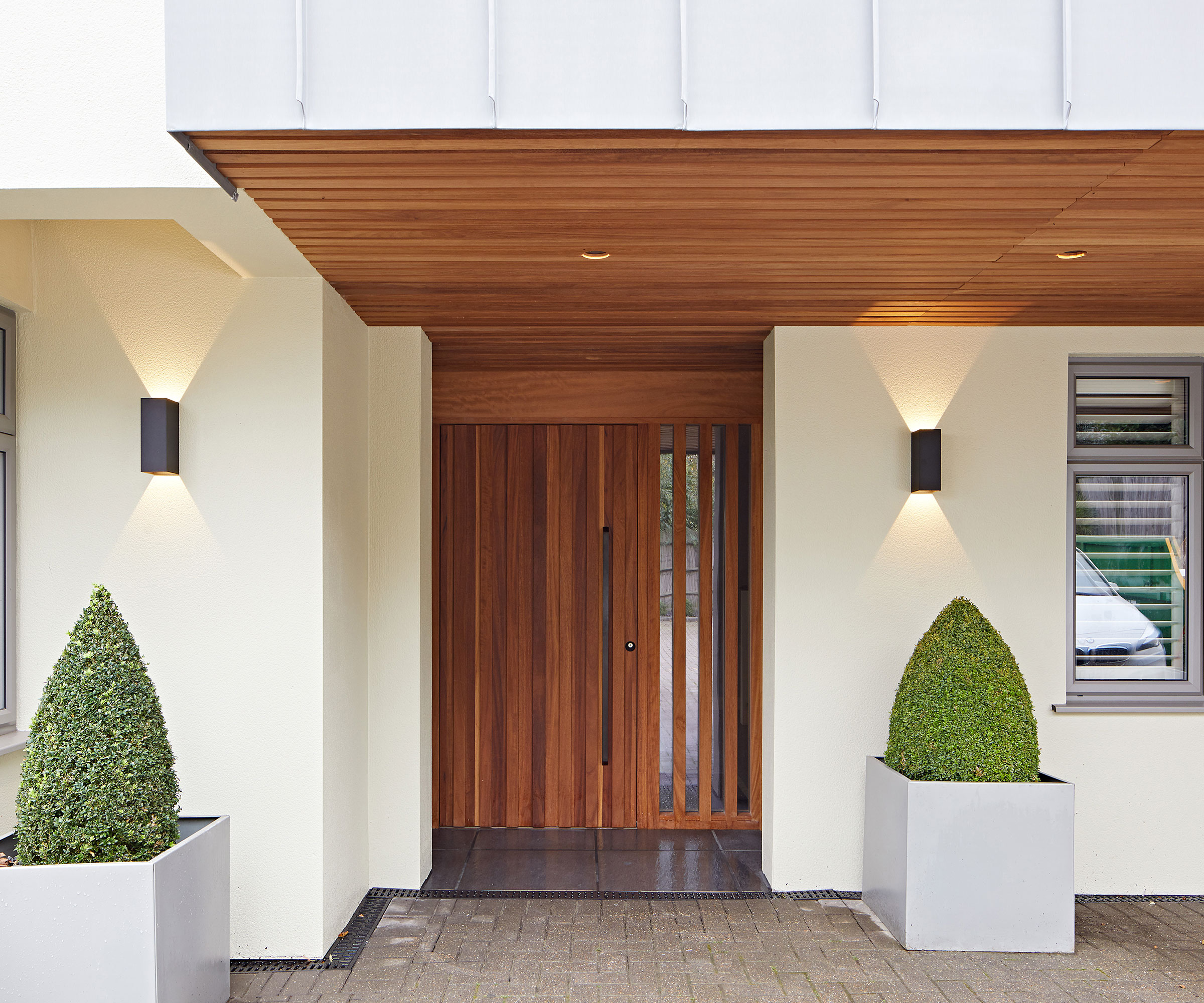 modern flat roof porch with modern timber and glass front door
