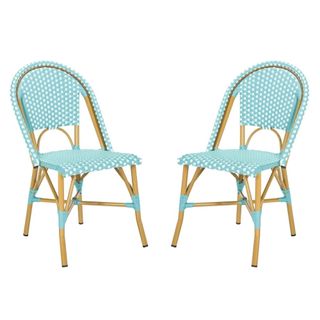 A pair of turquoise and white woven bistro chairs