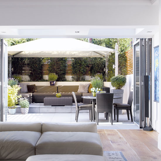 family room with sofa and potted plants