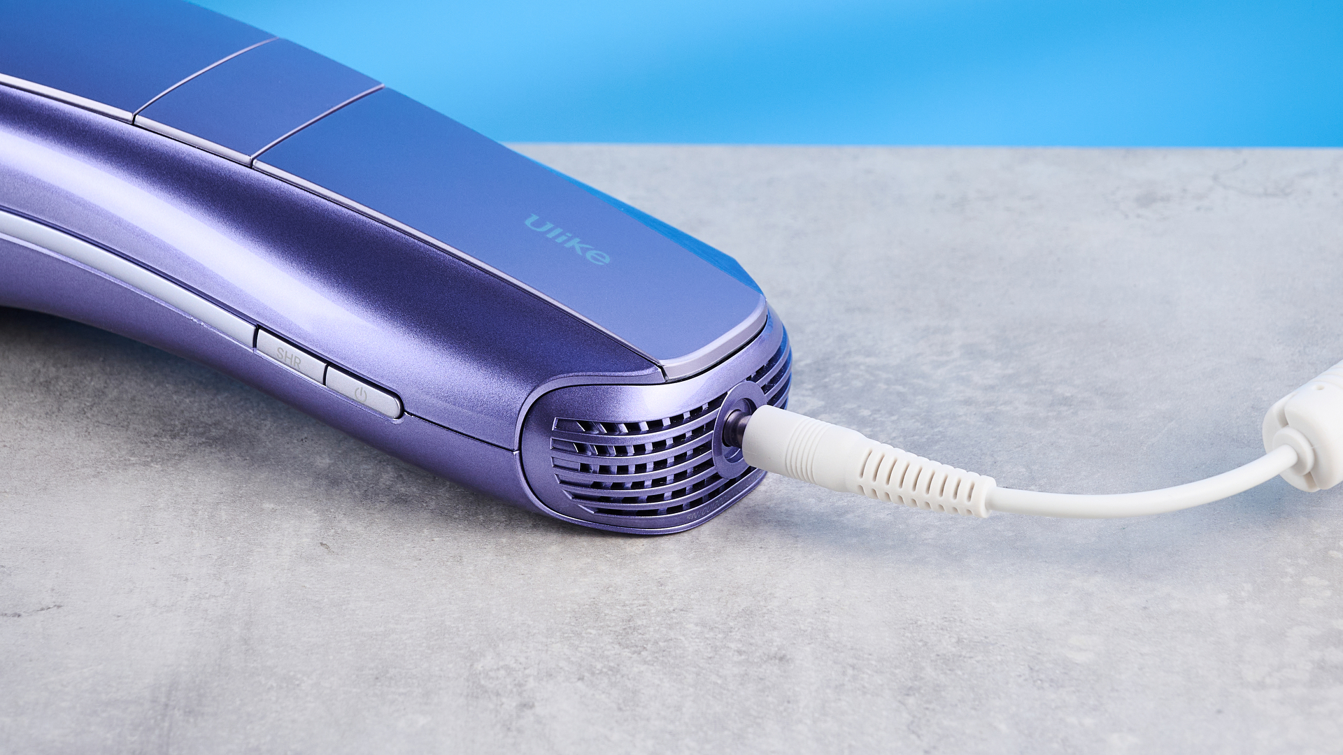 ULike Air 10 IPL machine photographed in front of a blue background.