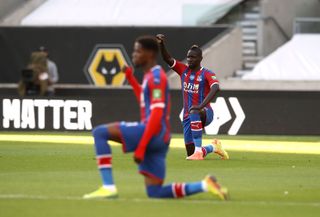 Wilfried Zaha takes a knee for Black Lives Matter prior to a Premier League game