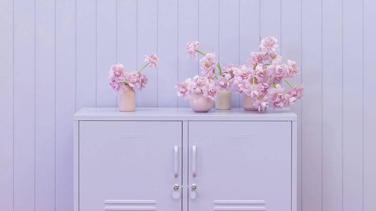 lilac cabinet against a lilac panelled wall 