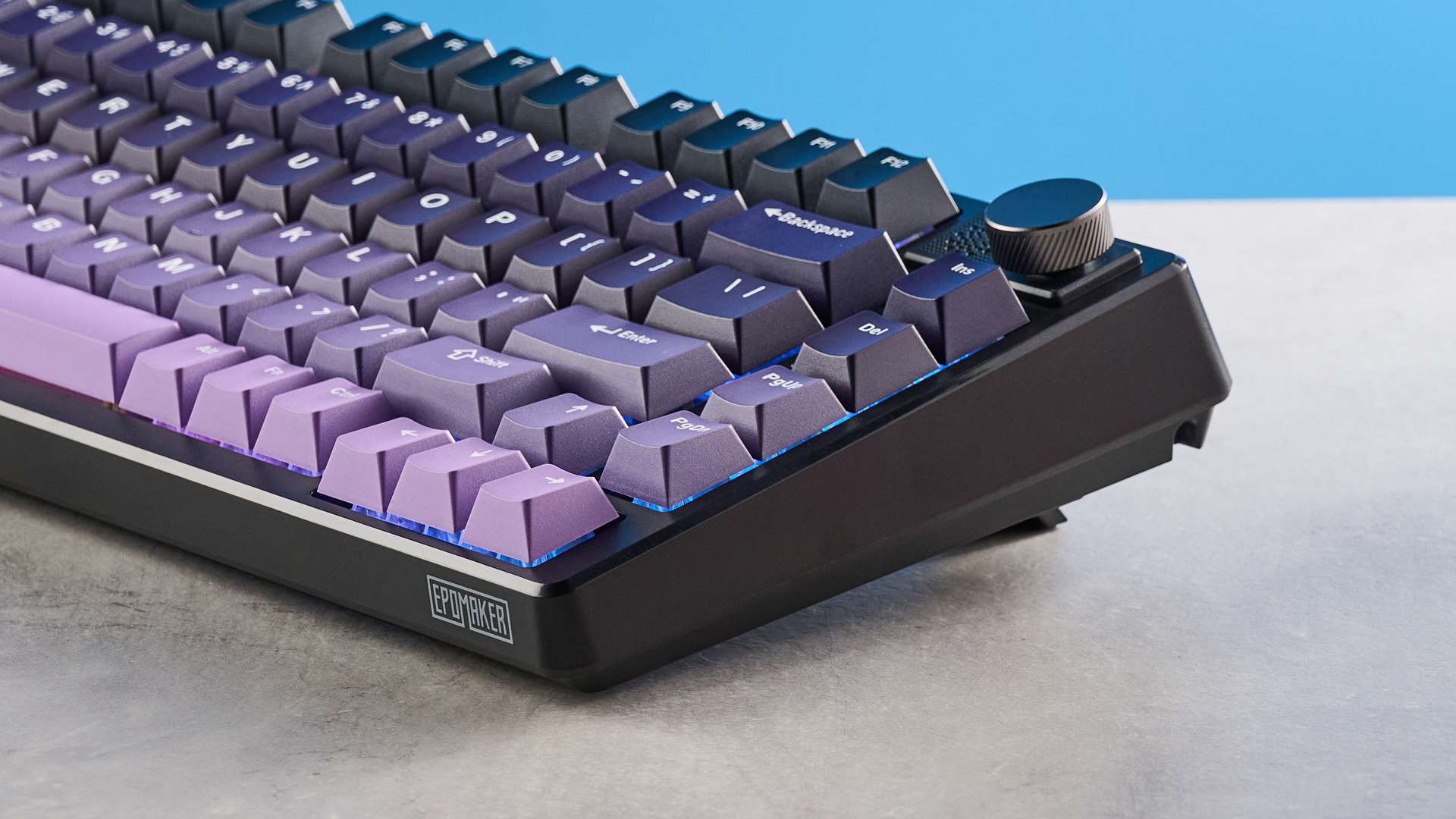 The Epomaker HE75 Mag on a stone surface with a blue background