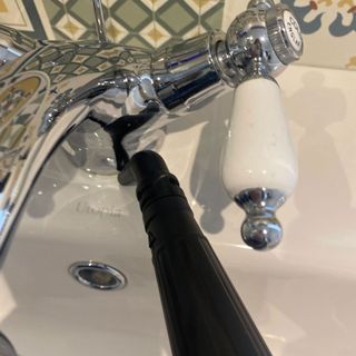 VAX steam fresh total home steam cleaner nozzle on taps at basin in bathroom