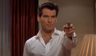 Pierce Brosnan aims his pistol, in a hotel suite, in Die Another Day