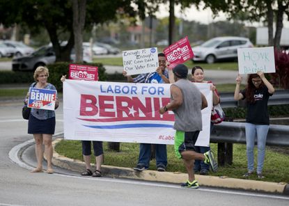 Bernie Sanders supporters protest the DNC ban on his access to voter data.