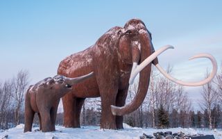 Mammoths (mother and baby) monument near road to Nadym town in Western Siberia, Russia.