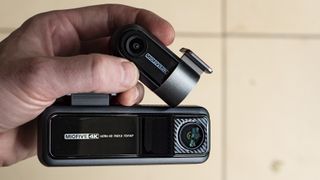 Miofive Dual Dash Cam front camera and rear camera in the hand