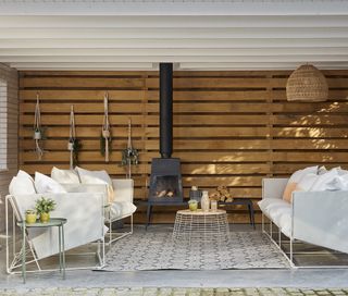 outdoor space with wood burning stove and sofa