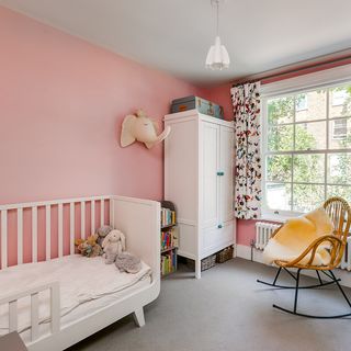 kids room with toddler bed and pink walls