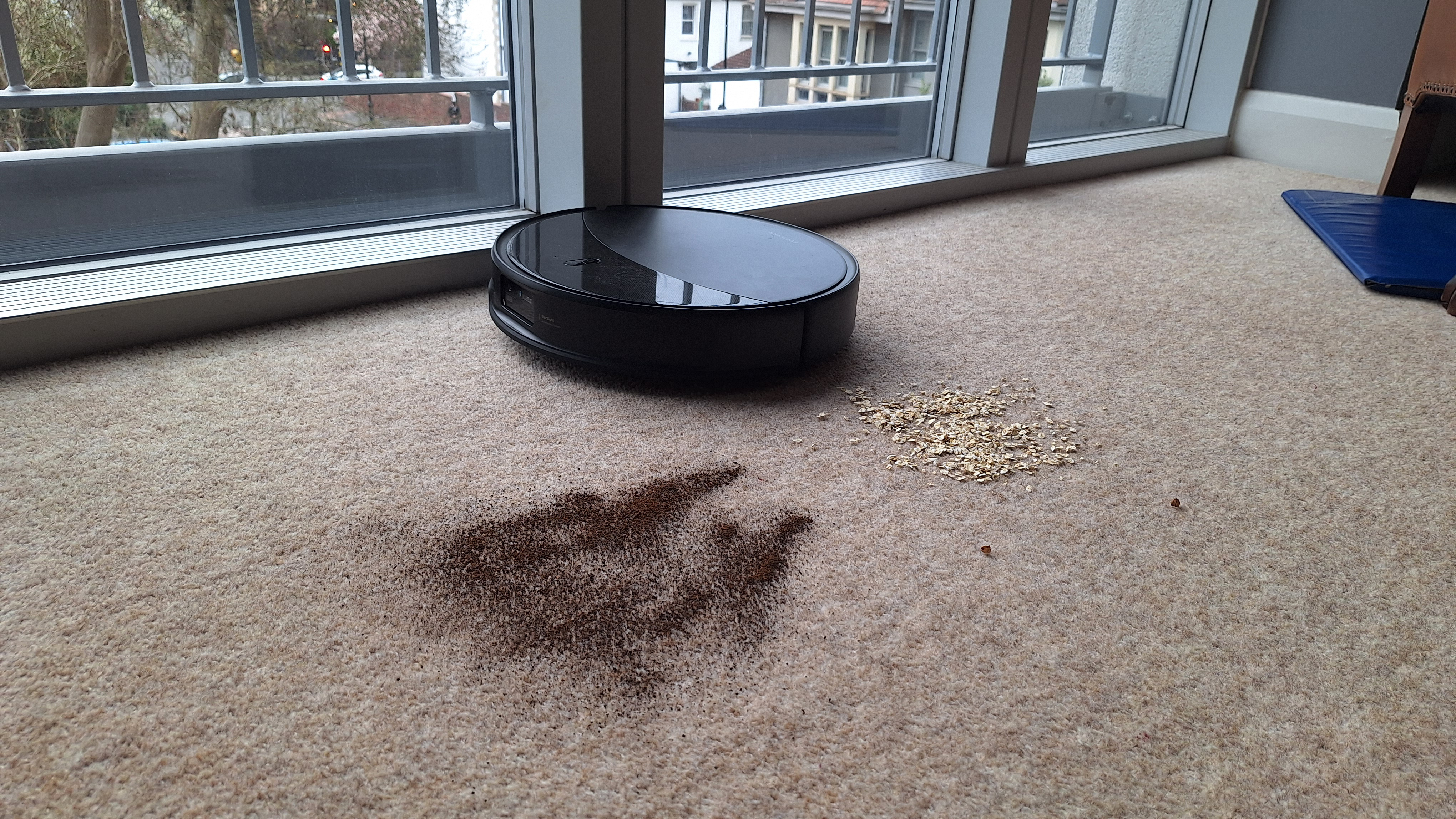 Roborock Saros 20 clearing oats and loose tea from a carpeted floor