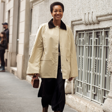 Woman wearing a barn jacket with a black skirt