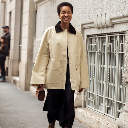 Woman wearing a barn jacket with a black skirt