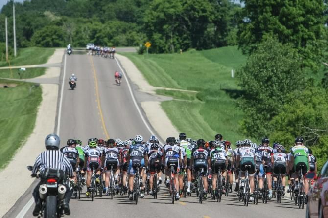 The main field watches as a group goes off the front.