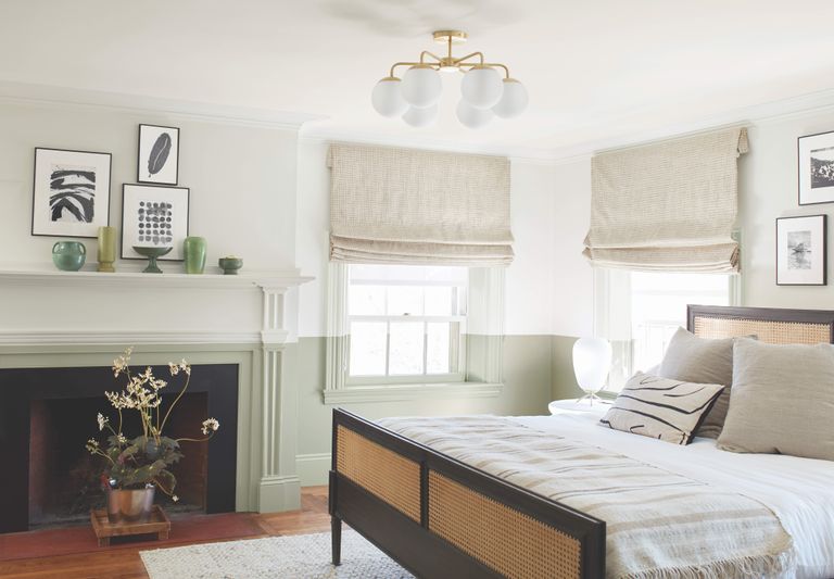 light green paint from Benjamin Moore's interior paint color trends 2022 on a bedroom wall with a double bed in the foreground