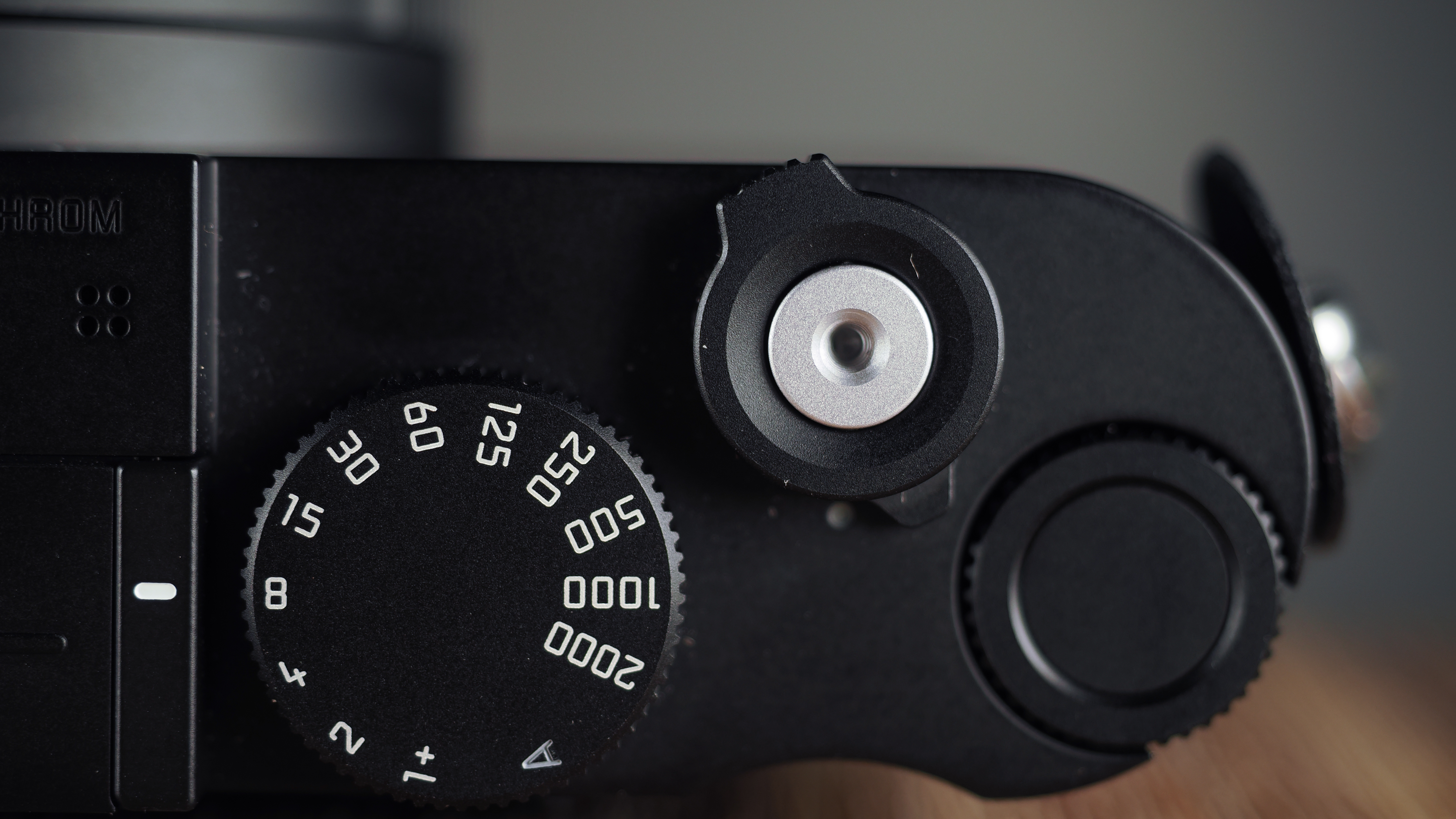 Leica Q3 Monochrom on a wooden surface