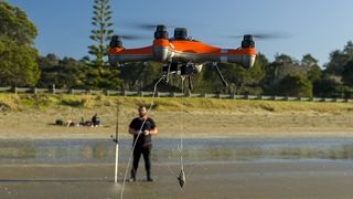 Fisherman flying a SwellPro drone on the edge of a lake