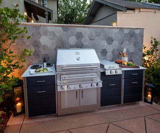 outdoor kitchen with grill and storage units