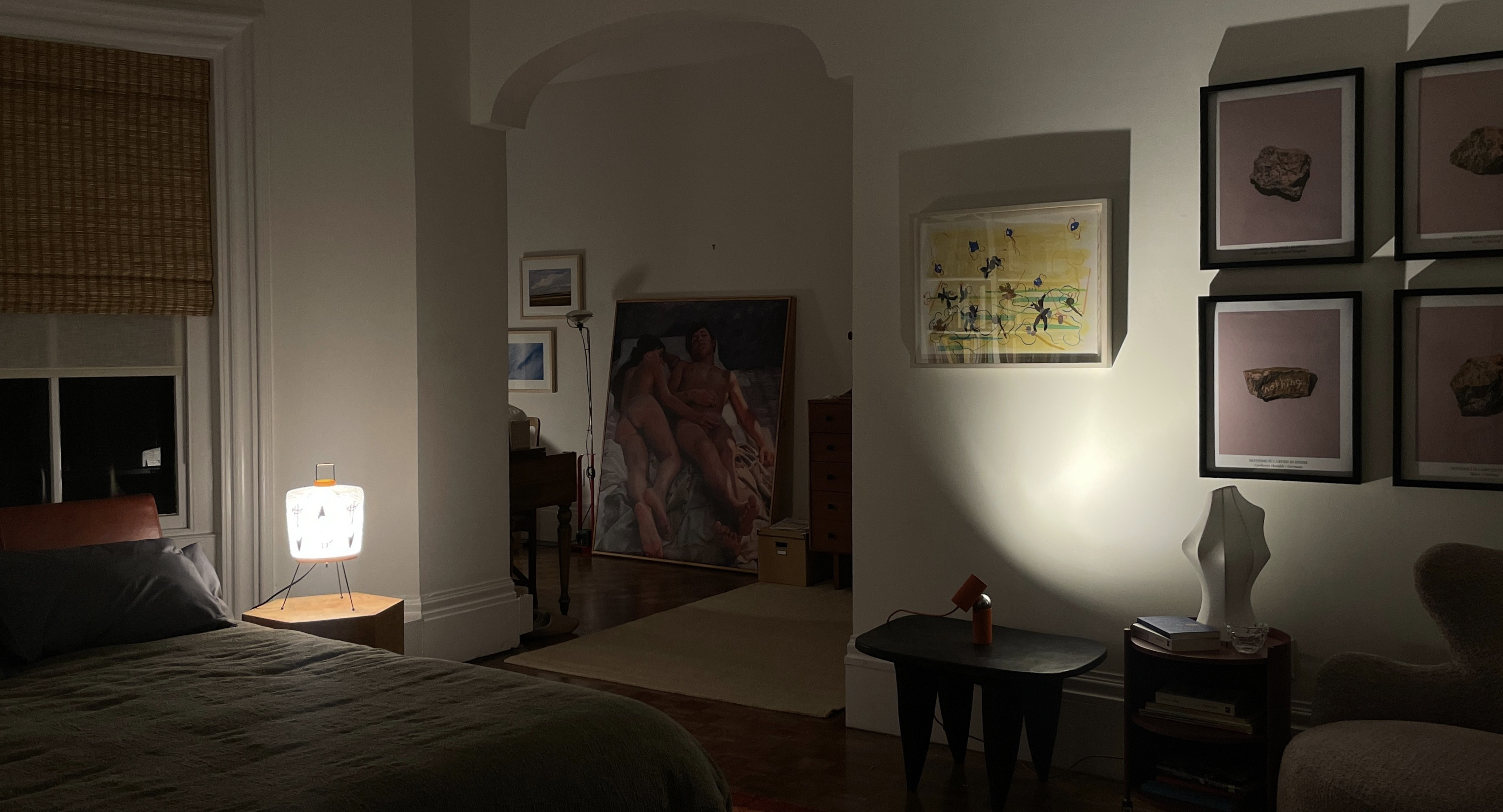 A series of interior shots of an art and objects-filled, dimly lit apartment, a museum's gallery rooms, an empty dance rehearsal room, and colorfully decorated office spaces.