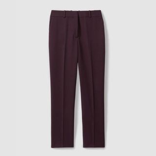 A cutout of burgundy tailored trousers against a light grey background