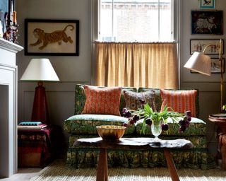 snug room with small patterned sofa and antique coffee table