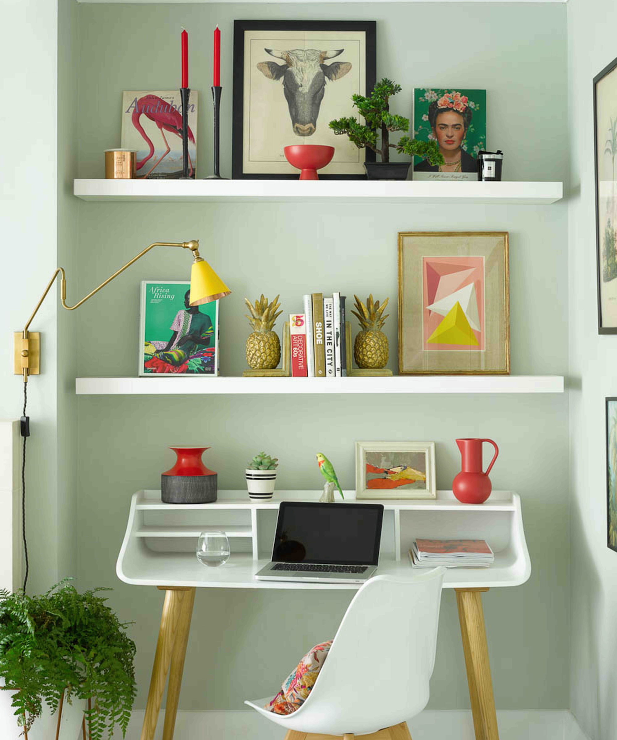 home office area in alcove with shelving and wall light with directional arm