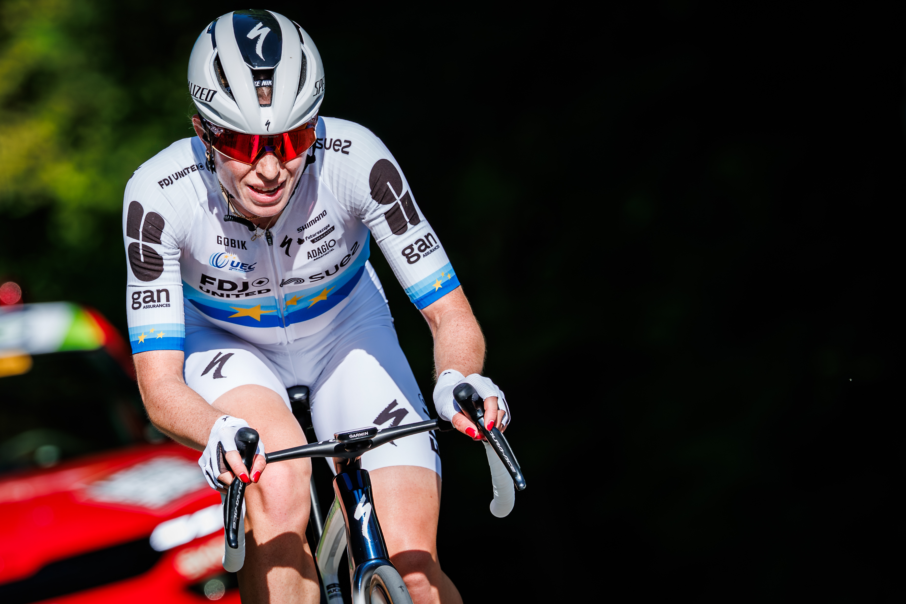 Demi Vollering rides alone ahead of the race commissaire's car during Liege-Bastogne-Liege