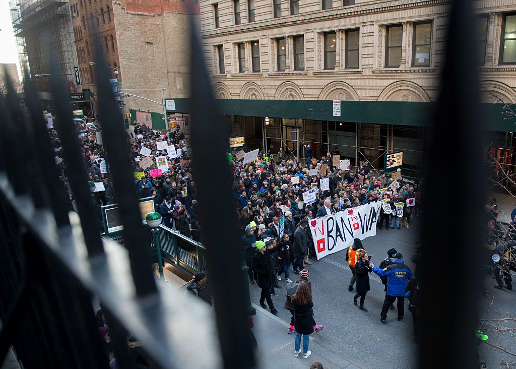 Protesters react.