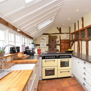 kitchen room with wooden kitchen worktop and oven with cabinet