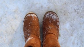 Close-up of warm boots, ugg boots in the snow