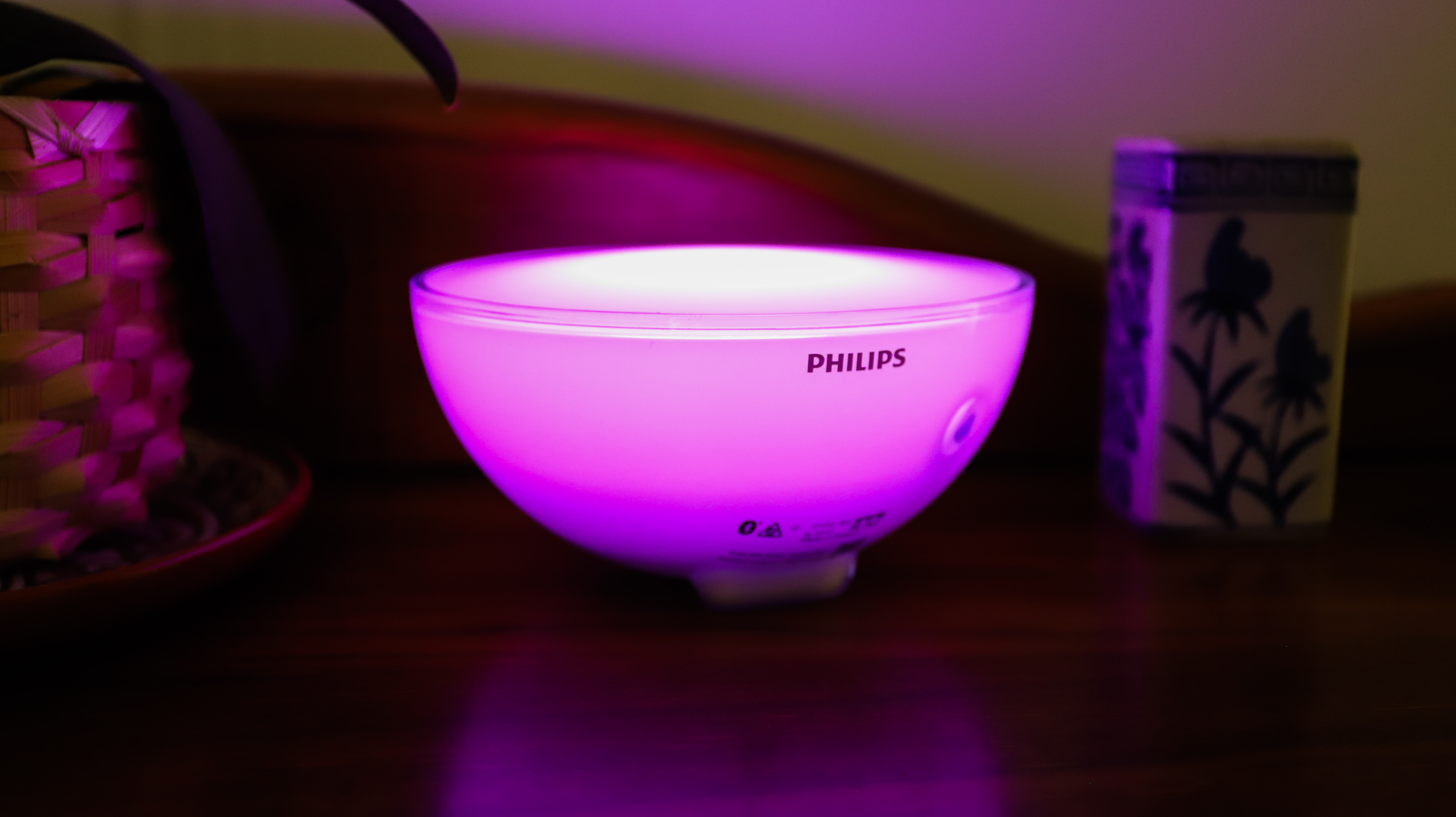 Philips Hue Go 2 di atas meja dalam cahaya merah jambu