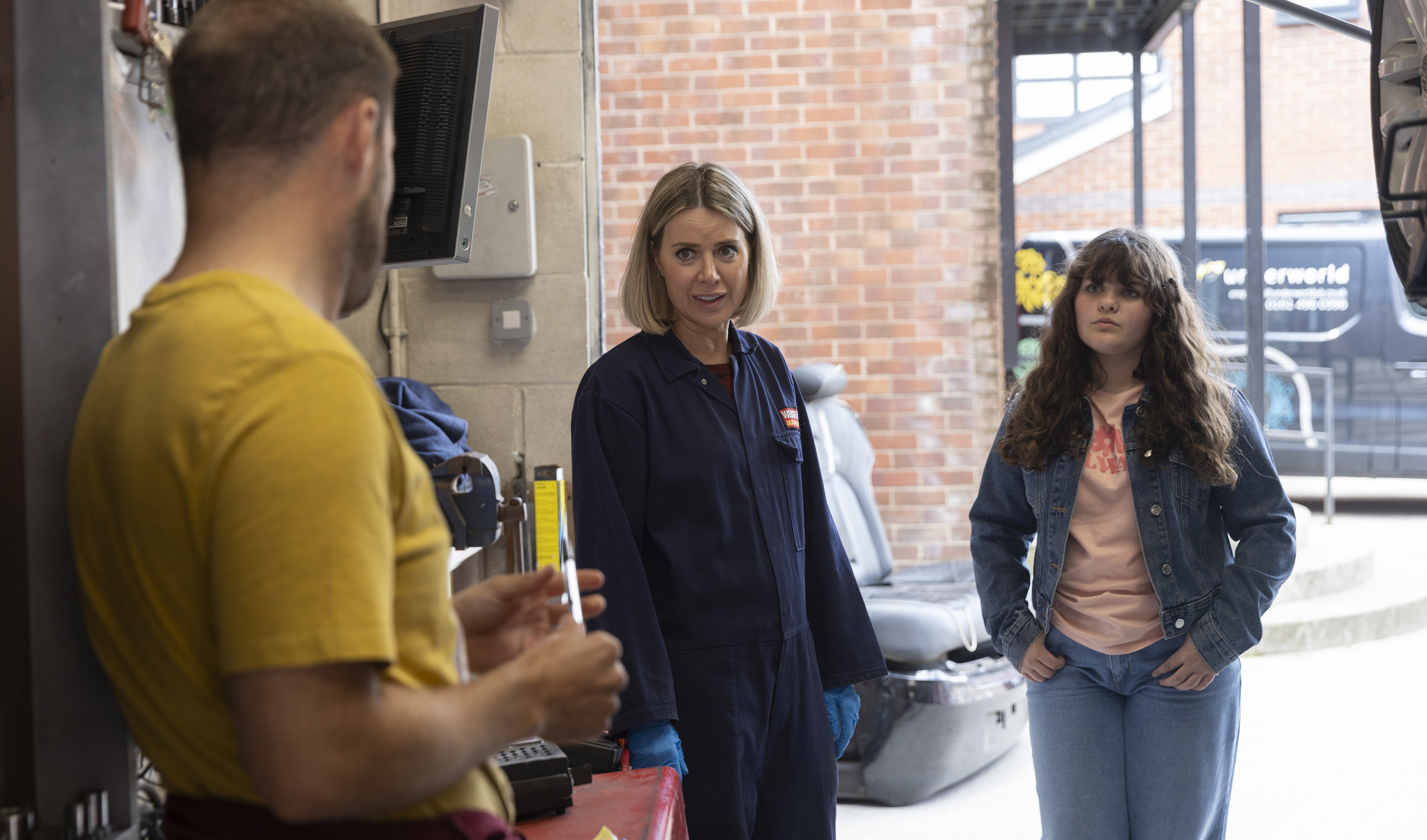 Tyrone Dobbs, Abi Webster and Hope Dobbs in the garage