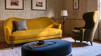 Love Your Home x Turner's House collection, including an antique-inspired sofa, footstool, and armchair pictured inside of a characterful English countryside living room