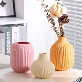 three ribbed vases in pink cream and yellow