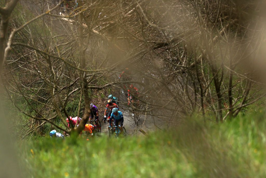 ARRATE SPAIN APRIL 09 Andrey Zeits of Kazahkstan and Team Astana Qazaqstan and a general view of the peloton competing through a wooded landscape during the 61st Itzulia Basque Country 2022 Stage 6 a 1357km stage from Eibar to Arrate itzulia WorldTour on April 09 2022 in Arrate Spain Photo by Gonzalo Arroyo MorenoGetty Images
