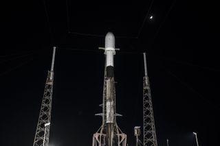 A SpaceX Falcon 9 rocket topped with the private Japanese Hakuto-R moon lander stands on the launch pad at Cape Canaveral Space Force Station in Florida. The rocket was supposed to launch on Dec. 1, 2022, but SpaceX is standing down to perform more checks on the rocket.