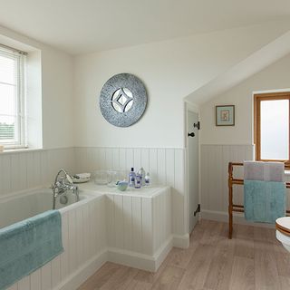 bathroom with wooden panelling and wooden floor