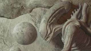 A screenshot of a segment of the Alien: Romulus poster showing a xenomorph looking down at something