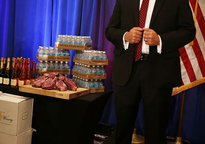 Trump water, wine, and steaks on display at a Donald Trump press conference in Florida.