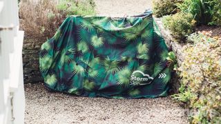 A bike covered by a tropical themed bike cover