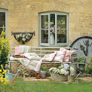 garden with table decorated with pillows